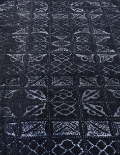 a black rug with white designs on it