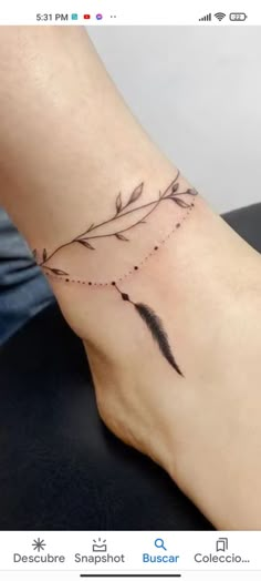 a woman's foot with an arrow tattoo on it