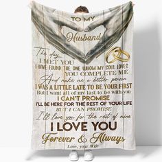 a wooden sign with the words i love you and two wedding rings