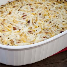 a casserole dish filled with cheese and bacon