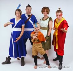 a group of people standing next to each other wearing costumes and posing for the camera