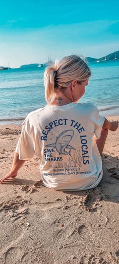 Dive into vintage style with our Shark Comfort Colors T-Shirt, perfect for great white shark enthusiasts. This unisex graphic tee, made from soft cotton, combines ocean conservation with nature-inspired design, making it a must-have for shark lovers. Comfort Colors C1717 Shirts - Shirt sizes are unisex, please refer to sizing chart in listing photos - 100% ring-spun cotton - Color blast effect will vary on every shirt. We cannot guarantee consistency among individual shirts. The Models in the pi Graphic Tee With Shark Design And Crew Neck, White Crew Neck Top With Shark Design, Respect The Locals, Save The Sharks, Ocean Shirt, Shark Design, Holiday Wishlist, Shark Lover, Surf Tshirt