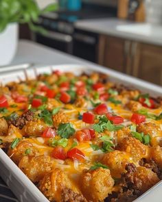 a casserole dish with meat, cheese and vegetables in it on a counter