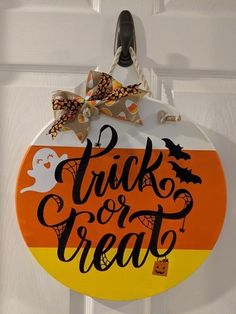 a trick or treat sign hanging on a door