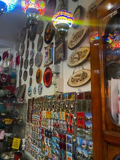 a store filled with lots of different types of items and lights hanging from the ceiling