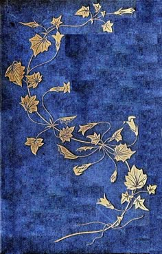 a blue rug with gold leaves and vines on the bottom, against a dark blue background