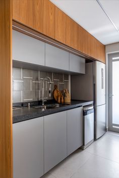 a kitchen with stainless steel appliances and wooden cabinets