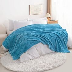 a bed with a blue blanket on top of it