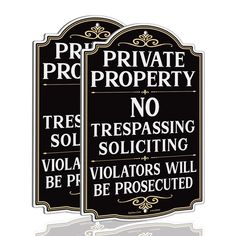 two black and white signs that say private property no trespassing or soliciting