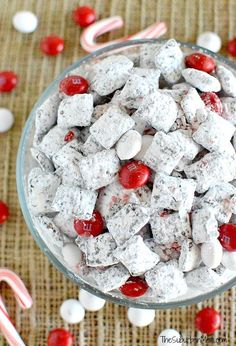 a bowl filled with marshmallows and candy canes on top of a table