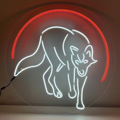 a neon sign with a wolf on it's side in the shape of a circle