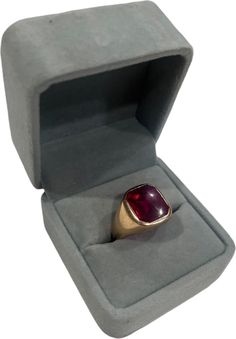 This vintage men's signet ring is crafted from 10k yellow gold and features a striking red ruby stone. The ring is set in a bezel style and has a band width of 4.5mm. The stone is synthetic and has been treated for maximum beauty. The ring is a perfect addition to any collection and can be worn for any occasion. It weighs 8.7 grams and is a size 13. The ring is signed and has an art deco era. The ring is made from gemstone and metal and has a unique style. Signet Ring Men, Ruby Stone, Art Deco Era, Gold Glass, Red Ruby, Ruby Ring, Signet Ring, Size 13, Vintage Men