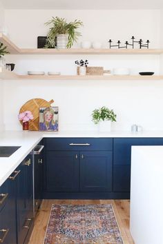 the kitchen is clean and ready for us to use it's blue cabinetry