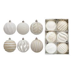 twelve white and gold christmas ornaments in a box