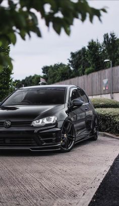 a black car parked on the side of a road