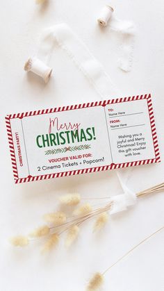 a christmas candy bar sitting on top of a white table next to some dried flowers