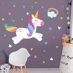 a child's room with a unicorn wall decal and stars on the walls