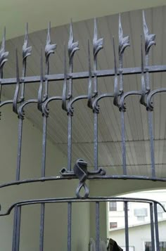 an iron gate with spikes on it in front of a mirror