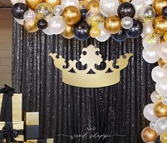 a black and gold birthday party with balloons, streamers, and a tiara