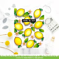 a card with lemons and flowers on it, surrounded by some other items that include scissors