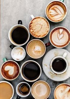 many cups of coffee are arranged in the shape of a heart on top of each other