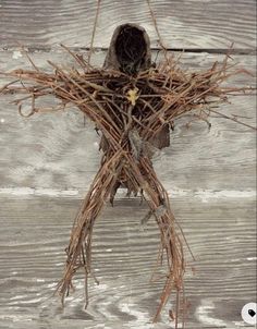 a bird sitting on top of a nest filled with twigs