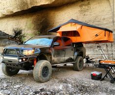 a truck with an orange tent attached to it