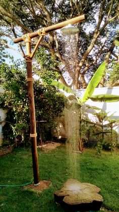 an outdoor shower in the middle of a yard