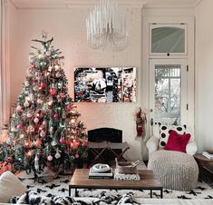 a living room decorated for christmas with a tree in the corner and decorations on the wall