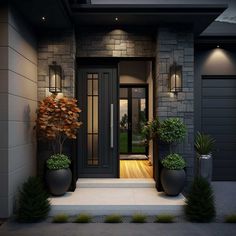 the front entrance to a modern house with two large planters and lights on it