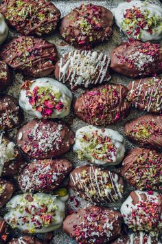 chocolate covered donuts with white frosting and sprinkles on top are shown