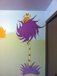 the dr seuss mural is painted on the wall