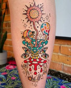 a tattoo on the leg of a woman with an image of mushrooms and sun above it