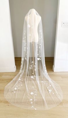 a white wedding veil with flowers on it