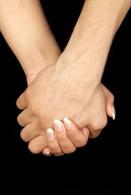 two hands holding each other with their fingers