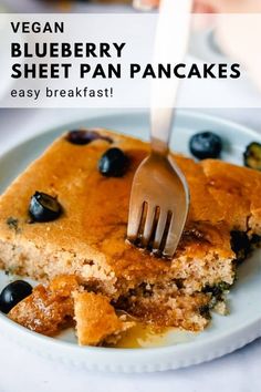 blueberry sheet pan pancakes on a white plate with a fork in it and text overlay that reads vegan blueberry sheet pan pancakes