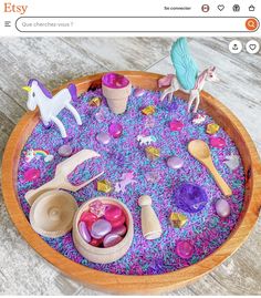 a wooden bowl filled with lots of toys and other items on top of a table