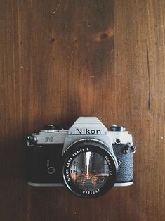 a camera sitting on top of a wooden table