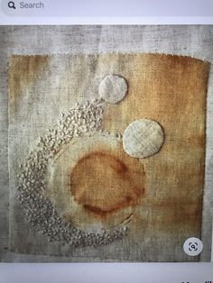 an abstract painting with circles and dots on fabric