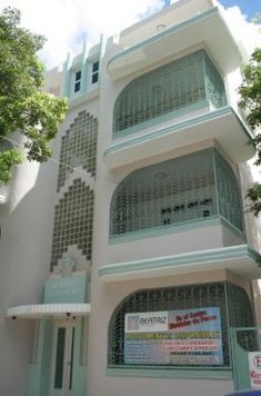 a tall white building with many balconies on it