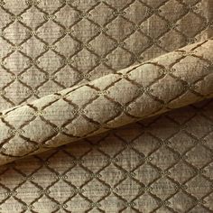 an upholstered fabric with gold and brown patterns on the outside, as seen from above