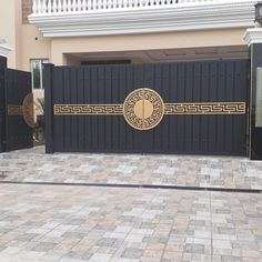 a large black gate in front of a building