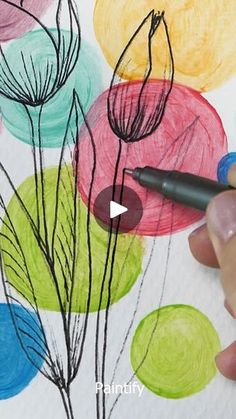 someone is drawing flowers with colored pencils