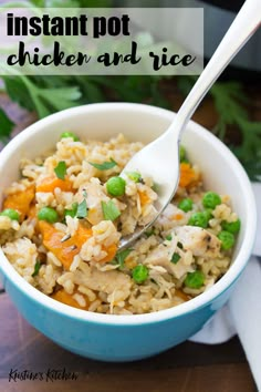 a bowl filled with rice, peas and carrots on top of a wooden table