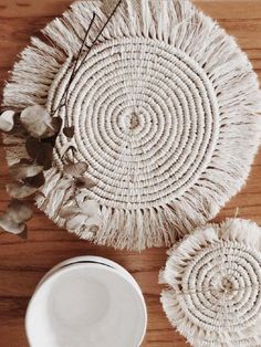 two white plates sitting on top of a wooden table next to a cup and saucer