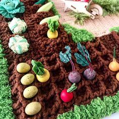 a crocheted table cloth with vegetables on it