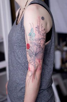 a woman with a flower tattoo on her arm