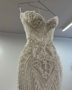 a white dress hanging on a clothes rack