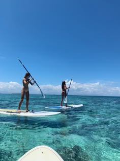 two people on paddle boards in the ocean