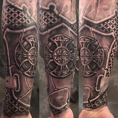 a man's arm with tattoos on it, and an image of a cross in the middle